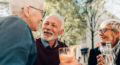 Aspire Blog - Holidays and hearing loss - three adults conversing outside having drinks