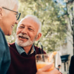 Aspire Blog - Holidays and hearing loss - three adults conversing outside having drinks