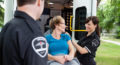 Aspire Blog - Medicare transportation benefits - women smiling while being loaded onto an ambulance