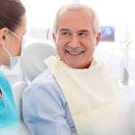 Aspire Blog - Medicare and Dental Coverage - Dental hygienist sitting with a dental patient