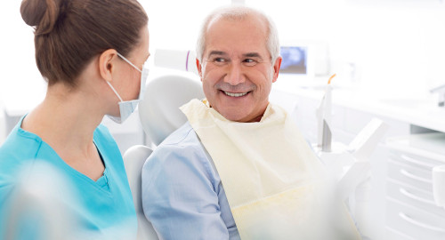 Aspire Blog - Medicare and Dental Coverage - Dental hygienist sitting with a dental patient