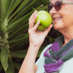Aspire Blog - Creating a Wellness Vision - Woman eating healthy holding an apple