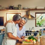 Happy older couple cooks a delicious, healthy meal following expert tips