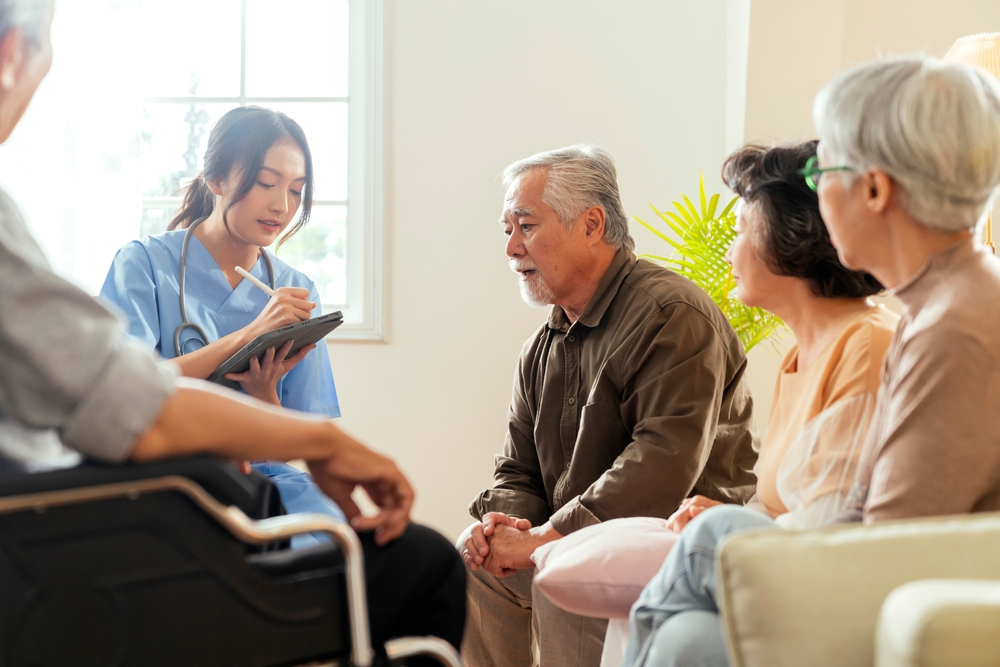 Nurse helps a group of older adults work on long-distance care plans with their caregivers